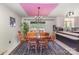 Cozy dining room featuring a unique pink ceiling, chandelier, and a patterned rug at 910 E Center Ave, Mooresville, NC 28115