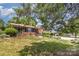 Charming brick home featuring a landscaped front yard and a cozy sunroom addition at 910 E Center Ave, Mooresville, NC 28115