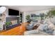 Bright living room featuring hardwood floors, a fireplace, and a comfortable sectional sofa at 910 E Center Ave, Mooresville, NC 28115