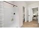 Bright bathroom featuring a modern shower and white interior doors at 9423 Weston Woods Ln, Charlotte, NC 28216
