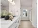 Bright bathroom featuring double vanity, quartz countertops, neutral walls, modern fixtures and natural light at 9423 Weston Woods Ln, Charlotte, NC 28216
