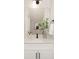 Stylish bathroom vanity with white cabinets, quartz countertop, matte black accents, and decorative mirror at 9423 Weston Woods Ln, Charlotte, NC 28216