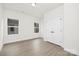 An empty room features natural light from the windows, hardwood-style flooring, and a closet at 9423 Weston Woods Ln, Charlotte, NC 28216