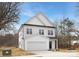 Exterior view of a two-story home with white siding, black roof, garage, and manicured lawn at 9423 Weston Woods Ln, Charlotte, NC 28216