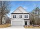 Exterior view of a modern two-story home featuring white siding, black accents, and well-kept lawn at 9423 Weston Woods Ln, Charlotte, NC 28216