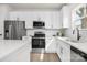 Well-appointed kitchen with stainless steel appliances and sleek white cabinetry at 9423 Weston Woods Ln, Charlotte, NC 28216