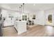 Modern kitchen with stainless steel appliances, white cabinets, and a central island at 9423 Weston Woods Ln, Charlotte, NC 28216