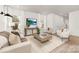 Bright living room featuring hardwood floors, a large TV, and comfortable seating at 9423 Weston Woods Ln, Charlotte, NC 28216