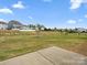 Large, grassy backyard with a playground in the distance at 9620 Fire Bellied Ct, Lancaster, SC 29720