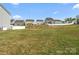 View of the home's backyard with a white fence and neighboring houses at 9620 Fire Bellied Ct, Lancaster, SC 29720