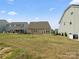 Home's backyard with a small tree, grass and view of neighboring houses at 9620 Fire Bellied Ct, Lancaster, SC 29720