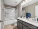 Bathroom with double sink vanity, large mirror, and shower-tub combination at 9620 Fire Bellied Ct, Lancaster, SC 29720
