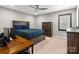 Carpeted bedroom with ceiling fan, dark wood furniture, and a window with dark blinds at 9620 Fire Bellied Ct, Lancaster, SC 29720