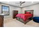 Bedroom showcasing a bed with red comforter, dresser, and plush carpet at 9620 Fire Bellied Ct, Lancaster, SC 29720