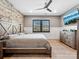 Spacious bedroom with stylish wood accent wall and a large window offering natural light and privacy at 9620 Fire Bellied Ct, Lancaster, SC 29720