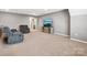 Carpeted bonus room with sofa, chair, and media center featuring neutral colors at 9620 Fire Bellied Ct, Lancaster, SC 29720