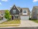 Charming two-story home with mixed siding, a manicured lawn, and a two-car garage on a sunny day at 9620 Fire Bellied Ct, Lancaster, SC 29720