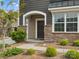 Inviting front porch with stone accents, an arched entryway, and well-maintained landscaping at 9620 Fire Bellied Ct, Lancaster, SC 29720