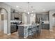 Modern kitchen featuring a large island, gray cabinets, stainless steel appliances, and pendant lighting at 9620 Fire Bellied Ct, Lancaster, SC 29720