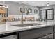 Close-up of the kitchen island featuring a stainless steel sink, modern faucet, and quartz countertop at 9620 Fire Bellied Ct, Lancaster, SC 29720