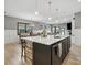 Open-concept kitchen boasts a large island with seating, pendant lighting, and views of the dining area at 9620 Fire Bellied Ct, Lancaster, SC 29720