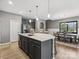 Open kitchen flows into the dining area, featuring a large island, stainless steel appliances, and ample counter space at 9620 Fire Bellied Ct, Lancaster, SC 29720