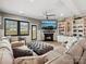Bright living room featuring a fireplace, flatscreen TV, large windows, and comfy seating for entertaining at 9620 Fire Bellied Ct, Lancaster, SC 29720