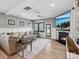 Comfortable living room with modern flooring, large windows, and a cozy fireplace with a flatscreen TV at 9620 Fire Bellied Ct, Lancaster, SC 29720