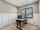 Well-lit office space with white wainscoting, hardwood floors, and a large window at 9620 Fire Bellied Ct, Lancaster, SC 29720