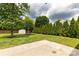 This backyard features a shed, mature landscaping, and a concrete patio area at 9916 Meadowmead Ct # 17, Charlotte, NC 28273