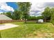 This backyard features a shed, mature landscaping, a tree, and a concrete patio area at 9916 Meadowmead Ct # 17, Charlotte, NC 28273