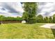 This backyard features a shed, mature landscaping, a tree, and a concrete patio area at 9916 Meadowmead Ct # 17, Charlotte, NC 28273