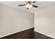 This bedroom features a ceiling fan, neutral walls, and dark wood-look flooring at 9916 Meadowmead Ct # 17, Charlotte, NC 28273