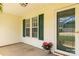 Charming front porch with a flower pot, green shutters, and a glass-paneled front door at 9916 Meadowmead Ct # 17, Charlotte, NC 28273
