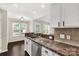 Modern kitchen bar overlooking living room with stainless steel dishwasher at 9916 Meadowmead Ct # 17, Charlotte, NC 28273