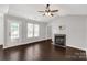 Bright living area with fireplace, fan, and expansive dark flooring with natural light at 9916 Meadowmead Ct # 17, Charlotte, NC 28273