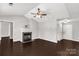 Bright living room with a fireplace, ceiling fan, and dark wood flooring at 9916 Meadowmead Ct # 17, Charlotte, NC 28273