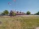 Stunning barn with multiple horse stalls, perfect for equestrian enthusiasts, is surrounded by lush landscaping at 1020 Equipoise Dr, Indian Trail, NC 28079