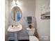 Powder room with pedestal sink, decorative mirror, and stylish fixtures at 1020 Equipoise Dr, Indian Trail, NC 28079