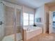 Bathroom featuring a glass shower, soaking tub, and bright lighting at 1020 Equipoise Dr, Indian Trail, NC 28079