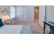 A bedroom with natural lighting, ample space, and a view of the doors and windows at 1020 Equipoise Dr, Indian Trail, NC 28079
