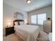 A bedroom featuring neutral decor, soft lighting, and two large windows at 1020 Equipoise Dr, Indian Trail, NC 28079