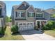 Beautiful two-story home with an attached garage, stone accents, and manicured landscaping at 1020 Equipoise Dr, Indian Trail, NC 28079