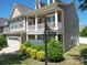 Charming home exterior with white columns, front porch and attached garage at 1020 Equipoise Dr, Indian Trail, NC 28079