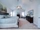 Bright main bedroom boasts a tray ceiling, ceiling fan, and elegant furnishings at 1020 Equipoise Dr, Indian Trail, NC 28079