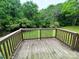 View of a back deck overlooking a green and wooded backyard at 1025 Martin Luther King Jr Dr, Albemarle, NC 28001