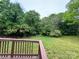 Back deck with a view of the lawn and surrounding trees at 1025 Martin Luther King Jr Dr, Albemarle, NC 28001