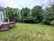 Spacious backyard and wood deck surrounded by lush trees at 1025 Martin Luther King Jr Dr, Albemarle, NC 28001