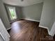 Bedroom featuring wood flooring and a window providing natural light at 1025 Martin Luther King Jr Dr, Albemarle, NC 28001