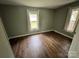 Cozy bedroom featuring wood flooring and two windows providing natural light at 1025 Martin Luther King Jr Dr, Albemarle, NC 28001